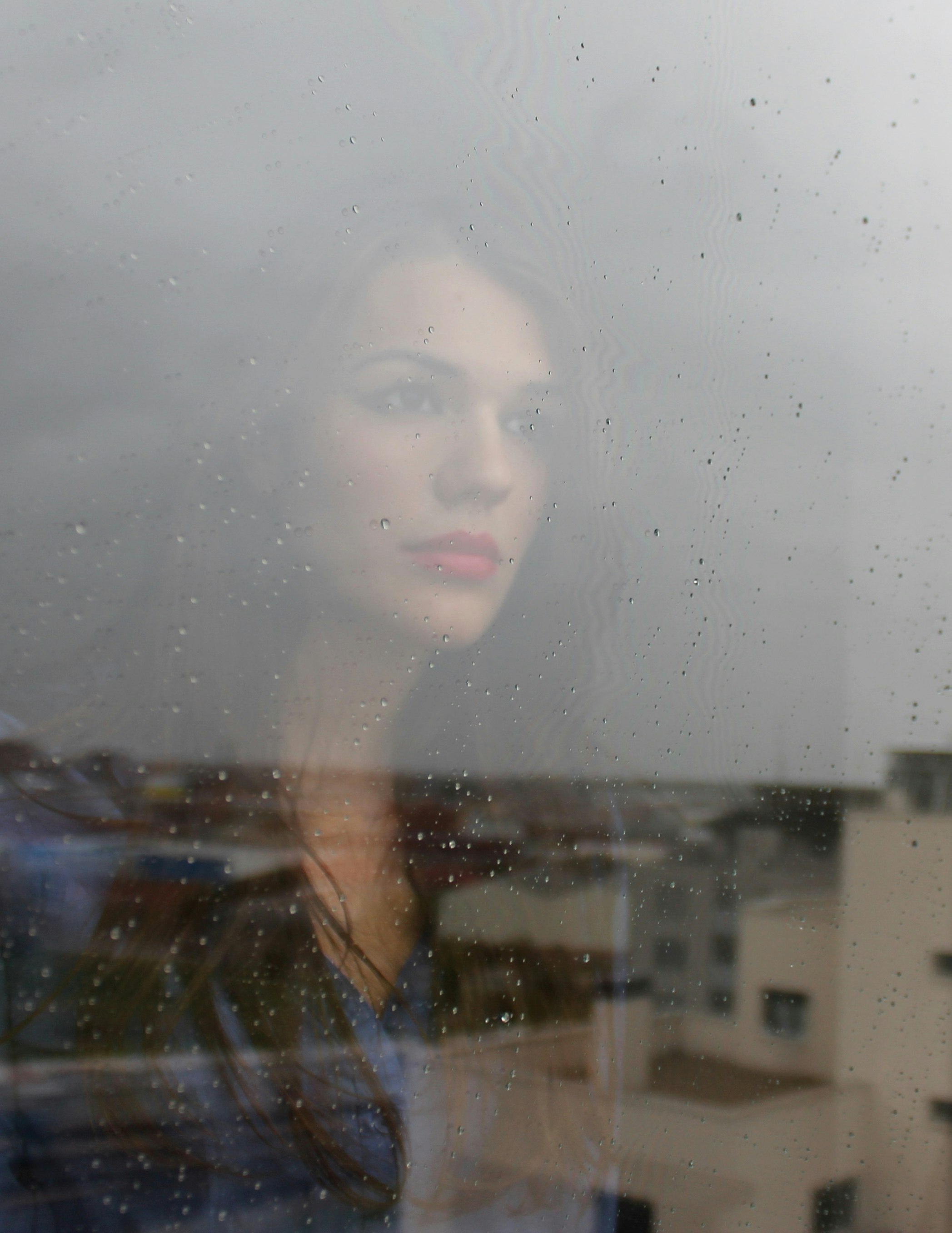 woman looking through window